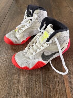 Nike Kids White High-Top Sneakers with Red Soles and Black Swoosh